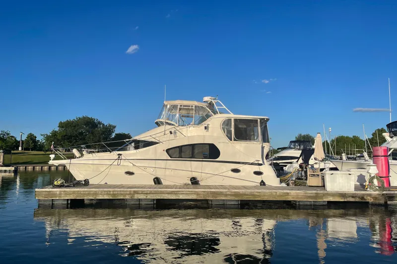  Yacht Photos Pics 2006 Silverton 35 Motor Yacht docked at a marina under a clear blue sky.