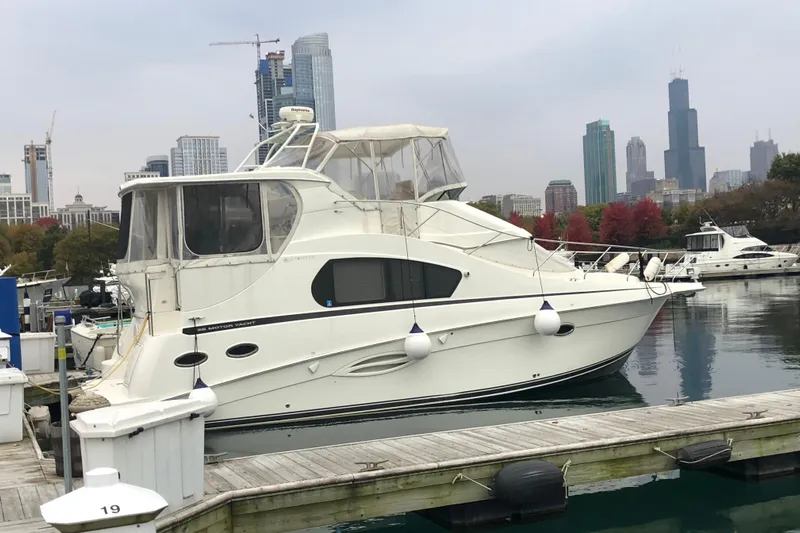  Yacht Photos Pics 2006 Silverton 35 Motor Yacht docked with city skyline in background.