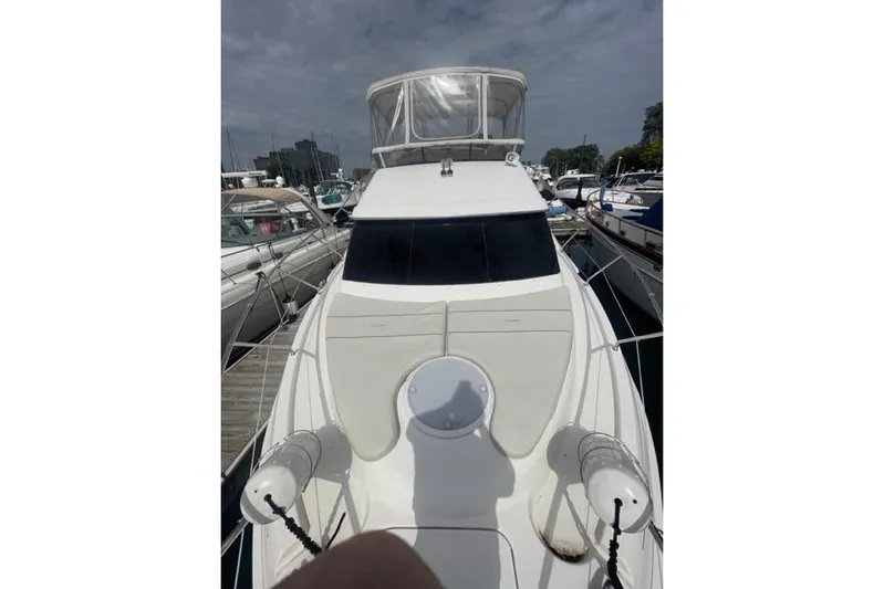  Yacht Photos Pics 2006 Silverton 35 Motor Yacht docked at marina under cloudy sky.