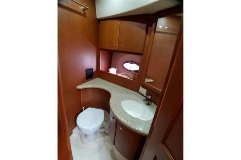  Yacht Photos Pics Luxurious bathroom in 2006 Silverton 35 Motor Yacht with wood cabinetry and modern fixtures.