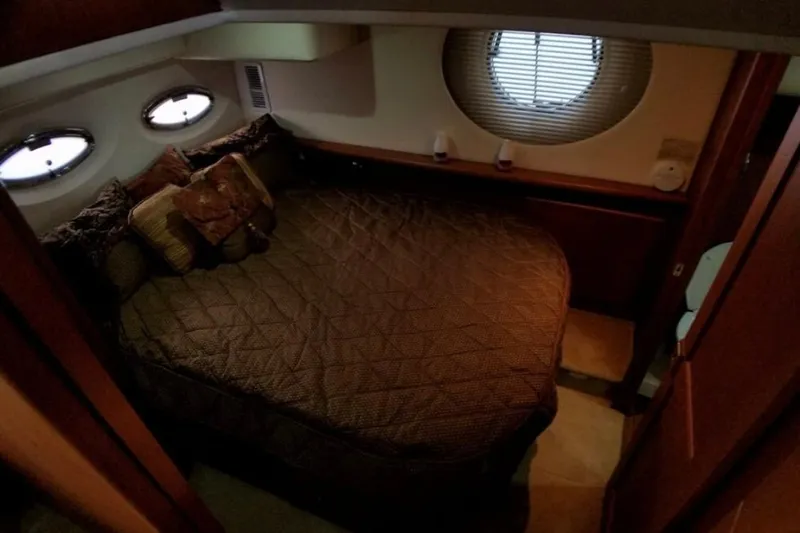  Yacht Photos Pics Cozy bedroom interior of 2006 Silverton 35 Motor Yacht with plush bedding and porthole windows.