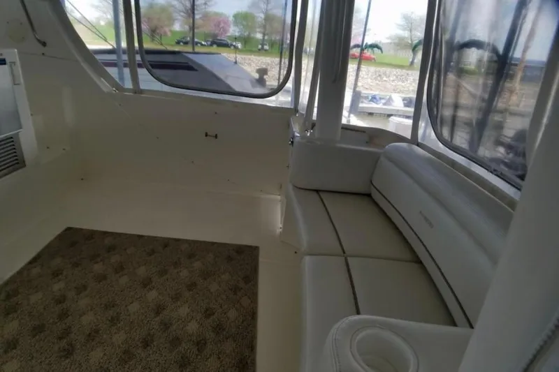  Yacht Photos Pics Interior of 2006 Silverton 35 Motor Yacht with white seating and carpeted floor.