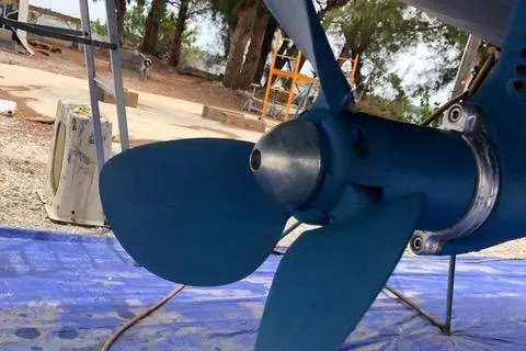 Serendipity Yacht Photos Pics Close-up of Jeanneau Sun Odyssey 469 sailboat propeller, 2014 model, on a blue tarp.