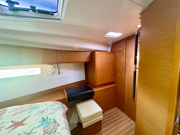 Serendipity Yacht Photos Pics Cozy cabin interior of 2014 Jeanneau Sun Odyssey 469 with wood finish and natural light.