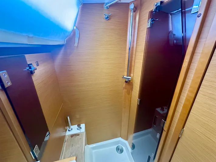 Serendipity Yacht Photos Pics 2014 Jeanneau Sun Odyssey 469 bathroom with wooden finish and modern fixtures.