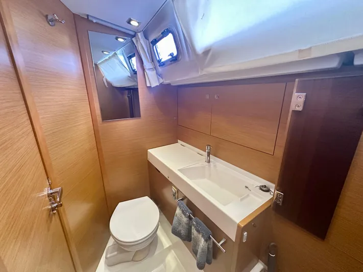 Serendipity Yacht Photos Pics Modern bathroom in 2014 Jeanneau Sun Odyssey 469 yacht, featuring sink and toilet.
