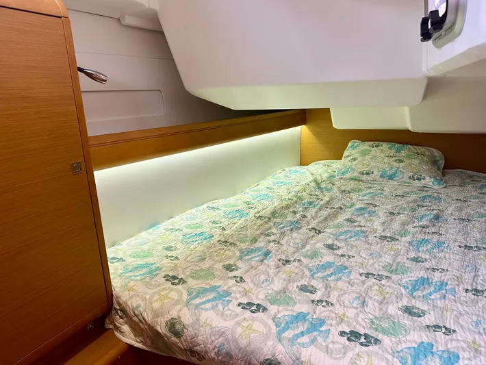 Serendipity Yacht Photos Pics Cozy cabin interior of 2014 Jeanneau Sun Odyssey 469 with patterned bedding.