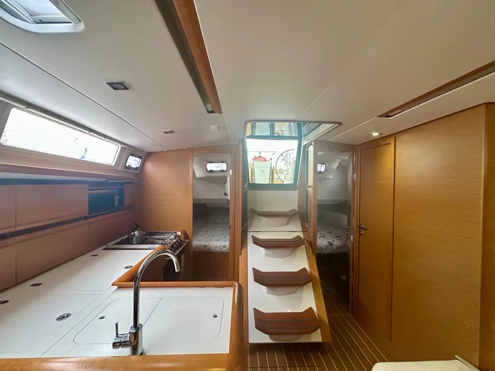 Serendipity Yacht Photos Pics Interior of 2014 Jeanneau Sun Odyssey 469 yacht, featuring a modern kitchen and cozy cabins.
