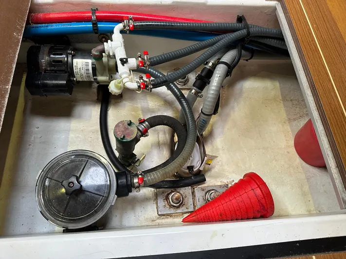 Serendipity Yacht Photos Pics Engine compartment of 2014 Jeanneau Sun Odyssey 469 with hoses and red funnel.
