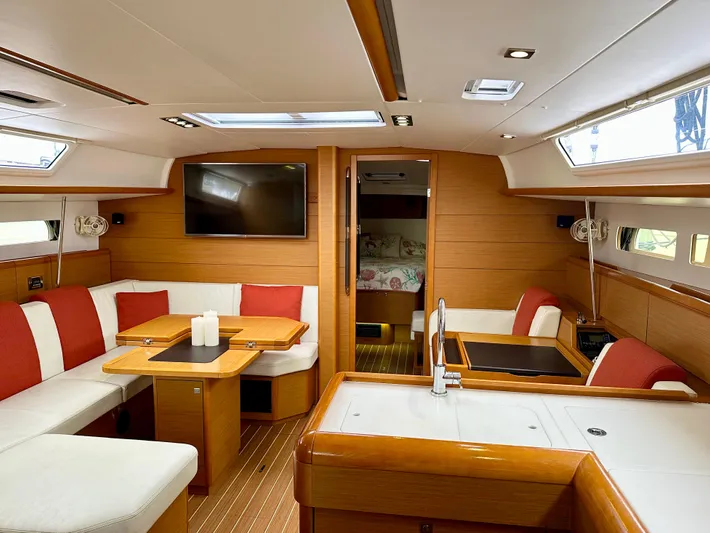 Serendipity Yacht Photos Pics Luxurious interior of 2014 Jeanneau Sun Odyssey 469 yacht with modern furnishings and ample seating.