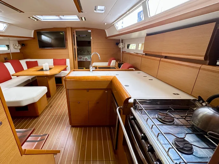 Serendipity Yacht Photos Pics Interior of 2014 Jeanneau Sun Odyssey 469 yacht with modern kitchen and dining area.