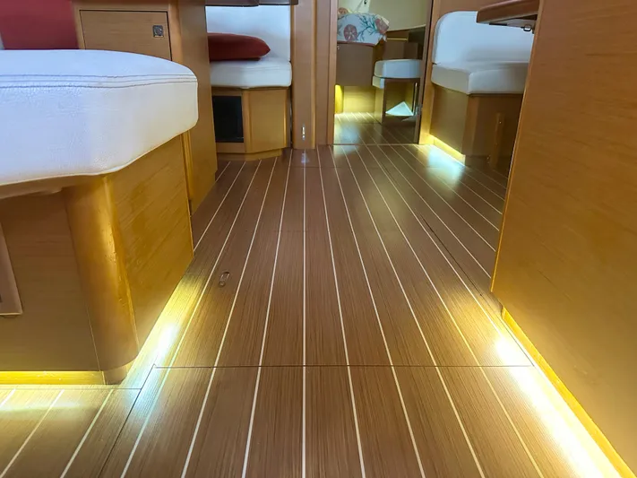 Serendipity Yacht Photos Pics Interior of 2014 Jeanneau Sun Odyssey 469 yacht with wooden flooring and ambient lighting.