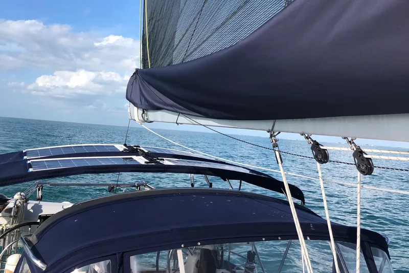 Serendipity Yacht Photos Pics Sailing on a 2014 Jeanneau Sun Odyssey 469 with solar panels and blue canvas covers.