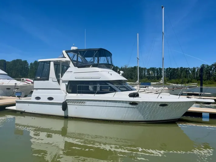  Yacht Photos Pics 2001 Carver 404 yacht docked in a marina under clear blue skies.