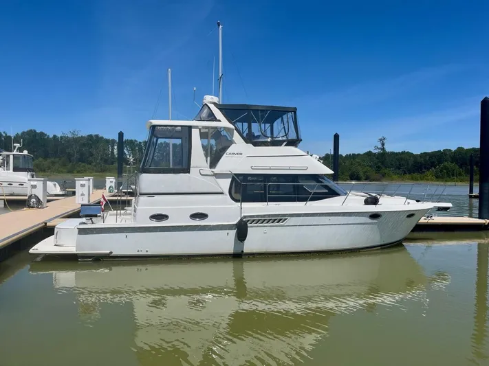  Yacht Photos Pics 2001 Carver 404 yacht docked at a marina under clear blue skies.