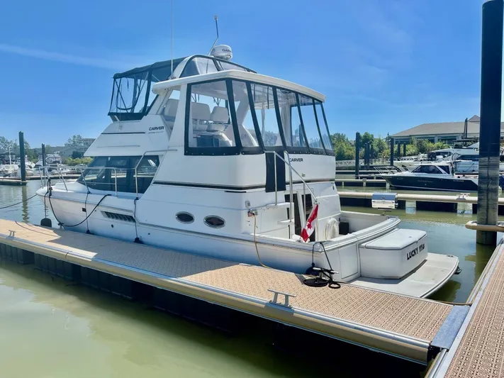  Yacht Photos Pics 2001 Carver 404 yacht docked at marina under clear blue sky.