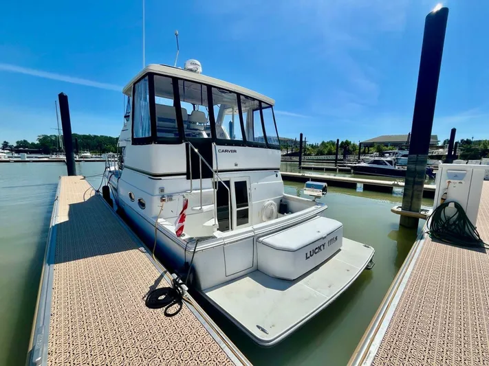  Yacht Photos Pics 2001 Carver 404 yacht docked at marina under clear blue sky.