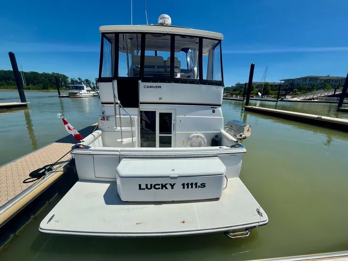  Yacht Photos Pics Carver 404 yacht from 2001 docked at marina, rear view with "Lucky 1111,s" name.