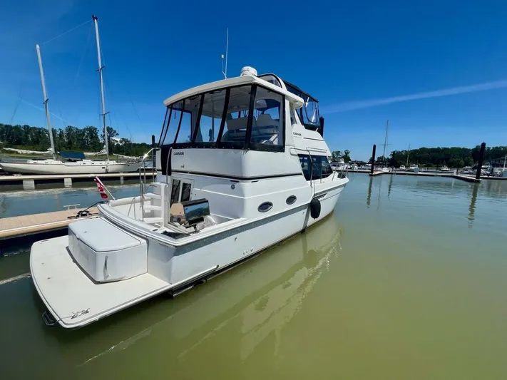  Yacht Photos Pics 2001 Carver 404 yacht docked at marina under clear blue sky.
