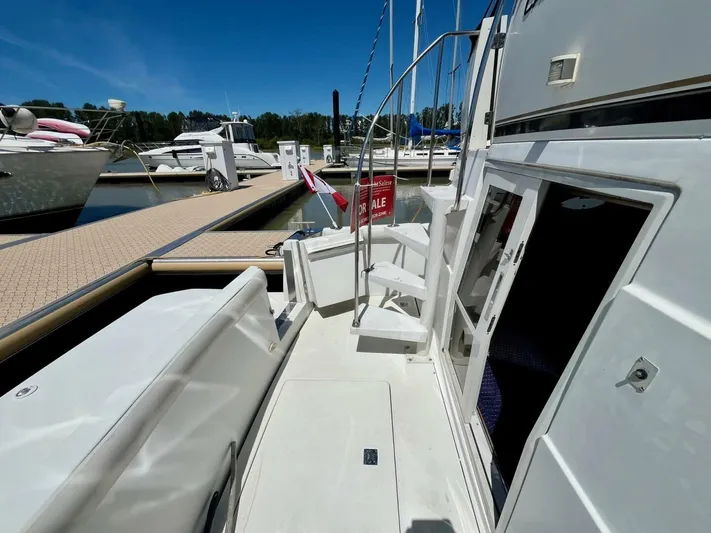  Yacht Photos Pics 2001 Carver 404 yacht docked, featuring open cabin door and "For Sale" sign.