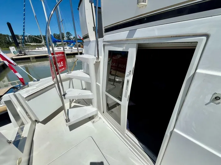  Yacht Photos Pics 2001 Carver 404 yacht for sale, docked with open cabin door and spiral staircase.