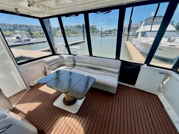  Yacht Photos Pics Luxurious interior of 2001 Carver 404 yacht with seating and table, docked at marina.