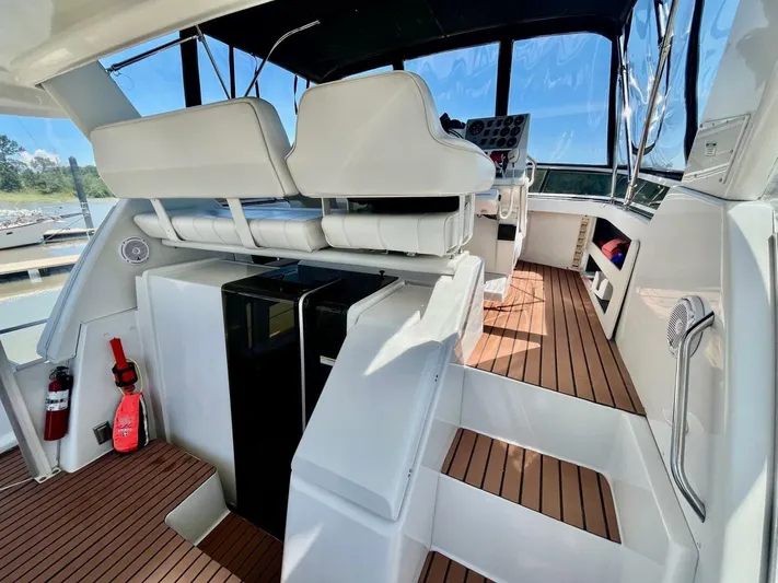  Yacht Photos Pics Interior of 2001 Carver 404 yacht with wooden flooring and white seating.