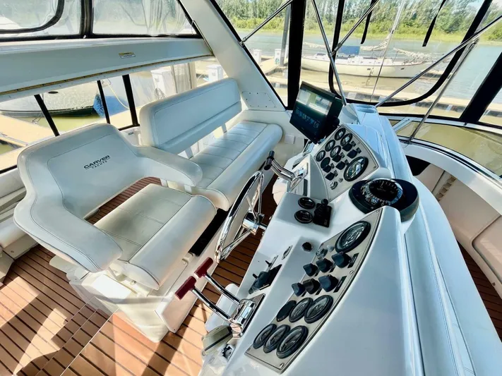  Yacht Photos Pics Interior of a 2001 Carver 404 yacht with helm controls and seating.