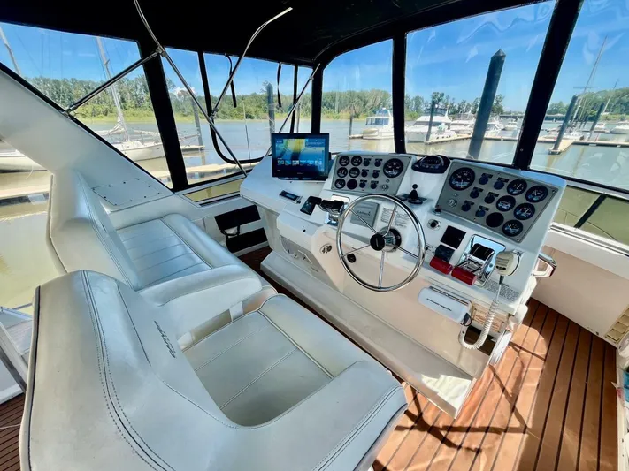  Yacht Photos Pics Interior of a 2001 Carver 404 yacht cockpit with steering wheel and control panel.