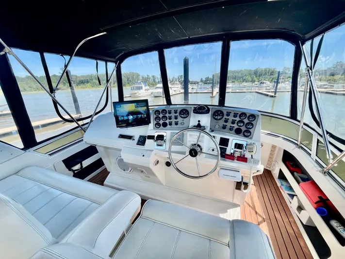  Yacht Photos Pics Interior view of 2001 Carver 404 yacht cockpit with steering wheel and control panel.