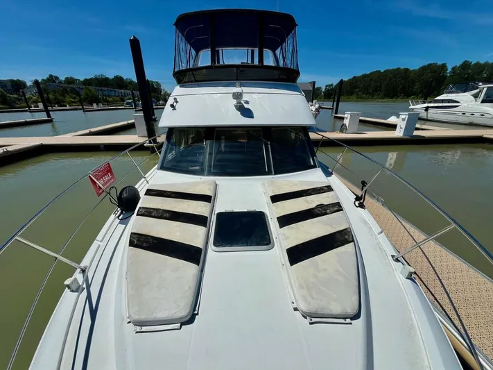  Yacht Photos Pics 2001 Carver 404 yacht docked, for sale, with clear blue sky and calm water.
