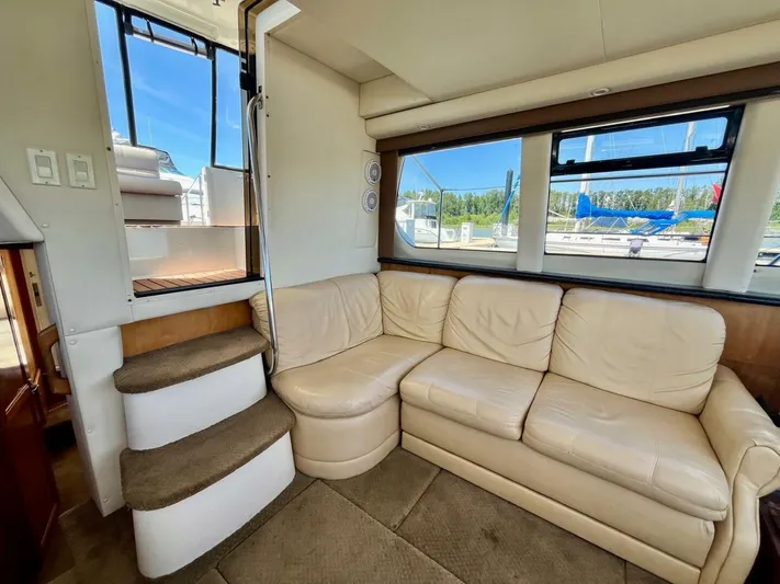  Yacht Photos Pics Interior of 2001 Carver 404 yacht with beige leather seating and carpeted steps.