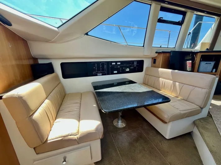  Yacht Photos Pics Interior of 2001 Carver 404 yacht with beige seating and black table.
