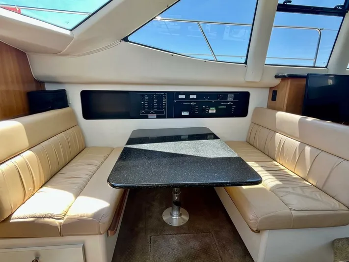  Yacht Photos Pics Interior of 2001 Carver 404 yacht with beige seating and black table.