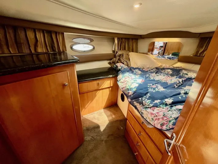  Yacht Photos Pics Cozy cabin interior of 2001 Carver 404 yacht with floral bedding and wooden cabinetry.