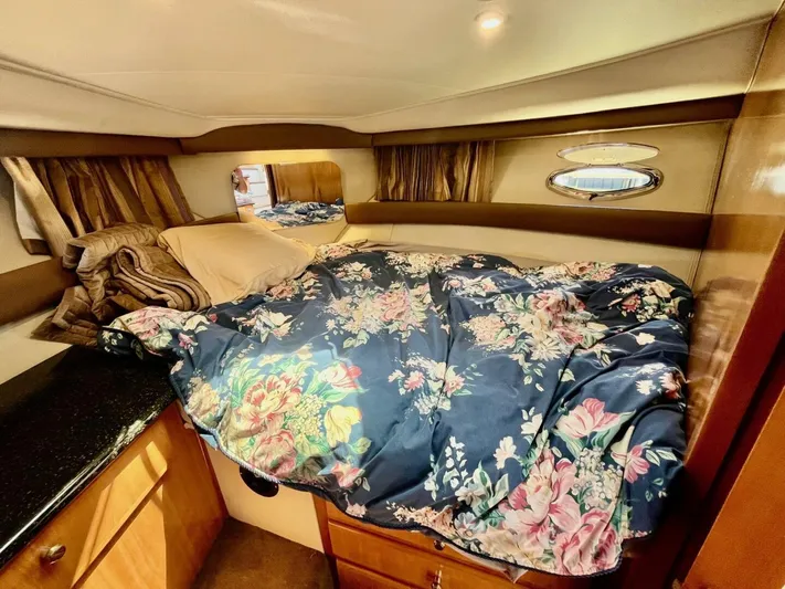  Yacht Photos Pics Cozy cabin interior of 2001 Carver 404 yacht with floral bedding and wooden cabinetry.