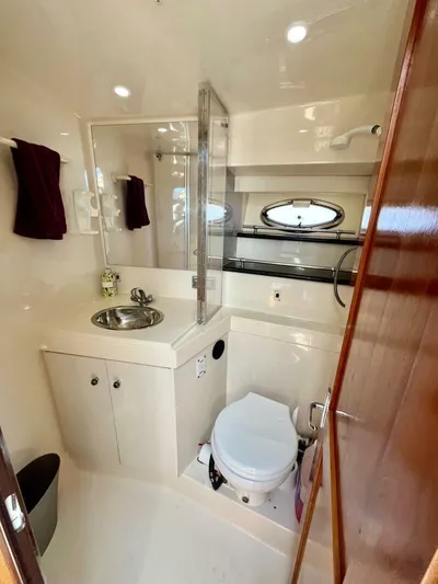  Yacht Photos Pics Luxurious bathroom in 2001 Carver 404 yacht with sink, toilet, and porthole window.