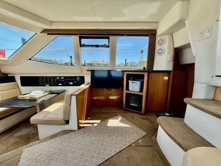  Yacht Photos Pics Interior of 2001 Carver 404 yacht with seating, table, and entertainment area.