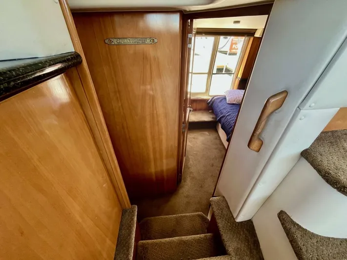  Yacht Photos Pics Interior of 2001 Carver 404 yacht showing stairs and cozy cabin with bed.