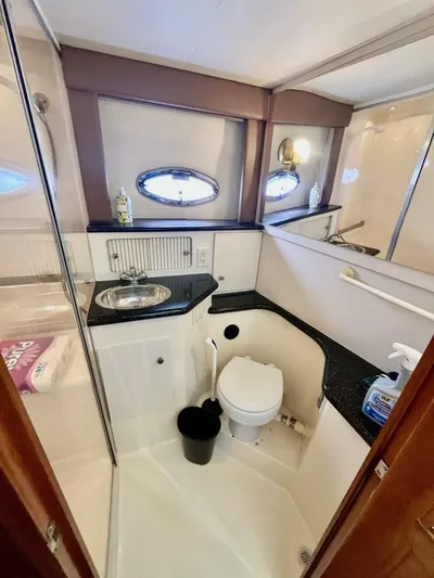  Yacht Photos Pics Bathroom interior of 2001 Carver 404 yacht, featuring sink, toilet, and porthole window.