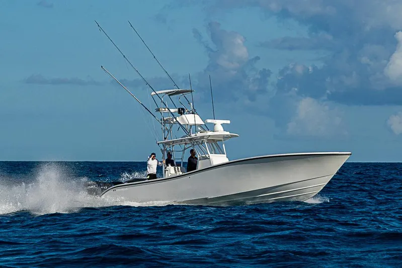  Yacht Photos Pics 2002 Yellowfin 36 Offshore boat cruising on open ocean under blue sky.