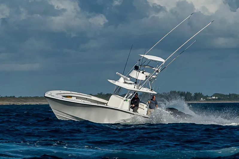  Yacht Photos Pics 2002 Yellowfin 36 Offshore boat navigating rough seas under cloudy skies.