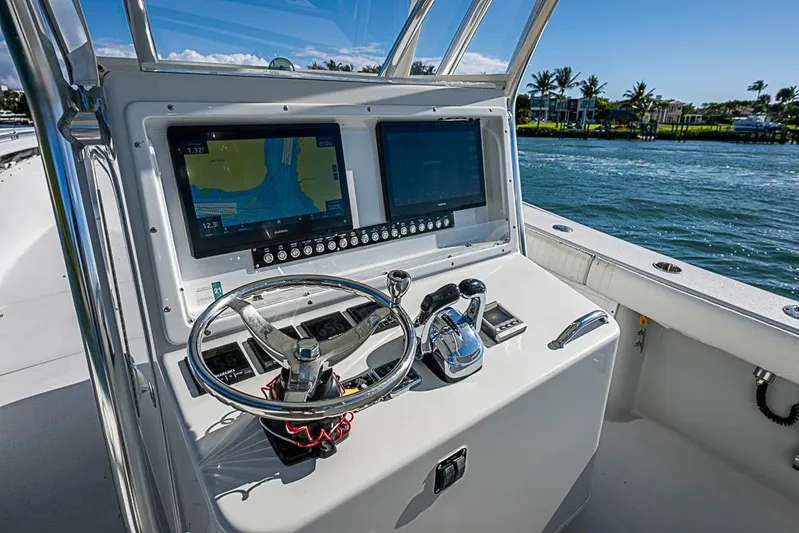  Yacht Photos Pics 2002 Yellowfin 36 Offshore boat helm with dual screens and steering wheel.