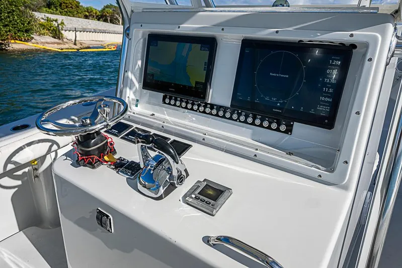  Yacht Photos Pics Control panel of a 2002 Yellowfin 36 Offshore boat with navigation screens.