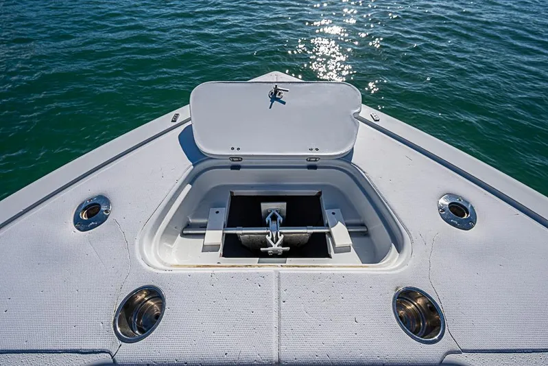  Yacht Photos Pics Bow of 2002 Yellowfin 36 Offshore boat with anchor compartment open on calm water.
