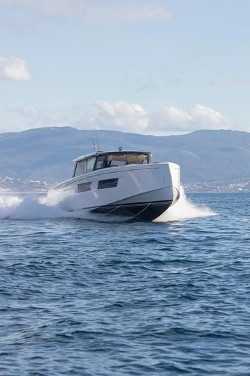 Grace Yacht Photos Pics 2023 Pardo Yachts GT52 cruising on open water with scenic mountain backdrop.