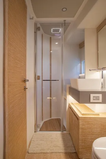 Grace Yacht Photos Pics 2023 Pardo Yachts GT52 bathroom with modern shower and wooden accents.