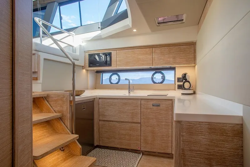 Grace Yacht Photos Pics Luxurious interior of 2023 Pardo Yachts GT52, featuring modern kitchen and elegant wood finishes.