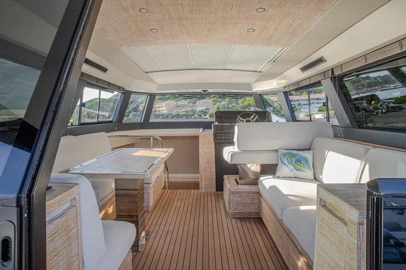 Grace Yacht Photos Pics Luxurious interior of 2023 Pardo Yachts GT52 with modern seating and wooden flooring.