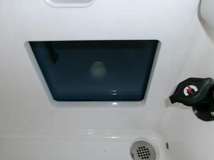  Yacht Photos Pics Livewell compartment on 2026 Blackfin 242 HB boat, featuring a drain and control knob.